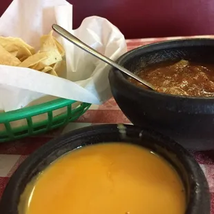 a bowl of soup and a basket of tortillas