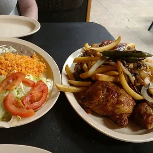 Smoked chicken with onions, peppers and fries, rice and beans