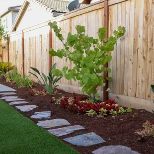 a garden with a wooden fence