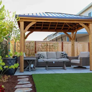 a patio with a wooden gazebo