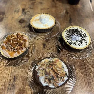 four different types of pies on a table