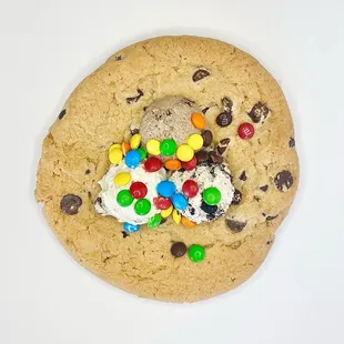Giant chocolate chip cookie "dressed" with mousse and toppings.