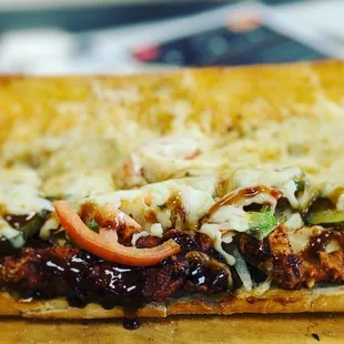 a sub sandwich with meat and vegetables