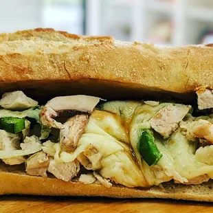 a chicken salad sandwich on a wooden cutting board