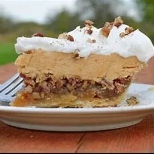 Autumn Harvest Pie- A layer of pecan pie with a silky pumpkin mousse, topped with whipped cream and candied pecans