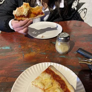 a woman eating a slice of pizza