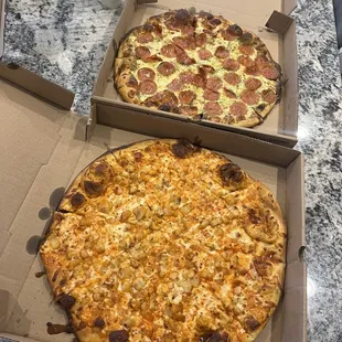 Buffalo chicken and Pesto pepperoni pizzas