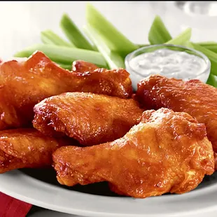 a plate of chicken wings and celery