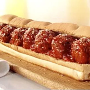 a hot dog on a wooden board