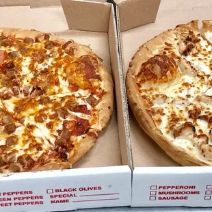 two pizzas in boxes
