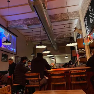 people sitting at tables in a restaurant
