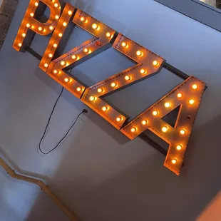 Pizza sign as you climb the stairs