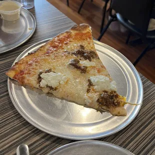 a slice of pizza on a plate