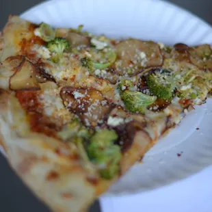 a slice of pizza on a paper plate