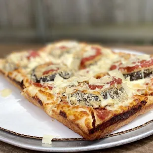 a slice of pizza on a plate