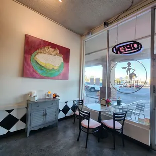 a table and chairs in front of a window