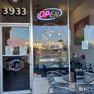 outside of a restaurant with tables and chairs