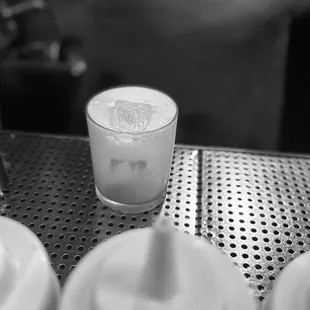 Green tea whiskey sour being made next to paper route