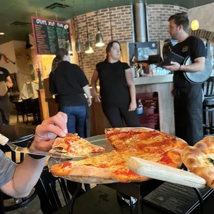 Grabbing a hot slice!