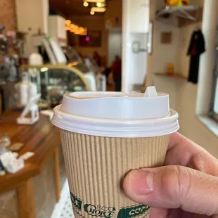 a person holding a cup of coffee
