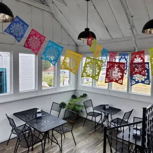 tables and chairs in a sunroom