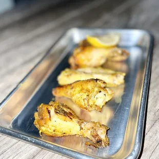 a tray of baked chicken wings