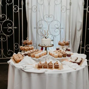 a table with a cake and cupcakes