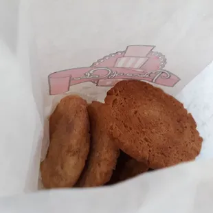 three cookies in a paper bag