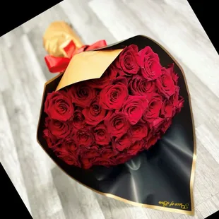 red roses wrapped in black paper