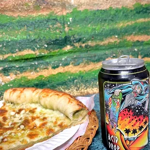 a slice of pizza next to a can of soda