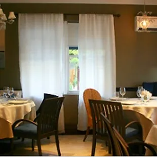 a dining room with tables and chairs