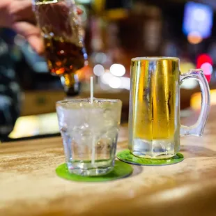 a person pouring a glass of beer