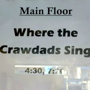 Sign announcing movie time and place