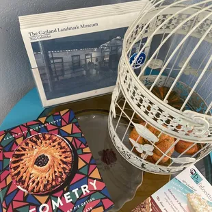 a birdcage and a book on a table
