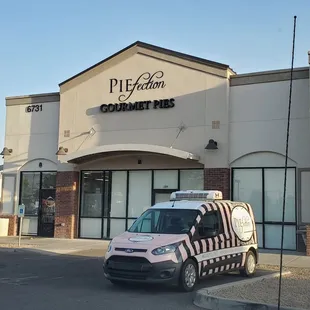 a van parked in front of a bakery