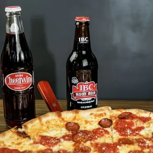 a pepperoni pizza and two bottles of beer