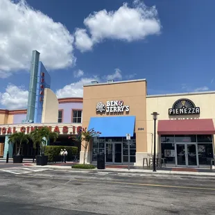 2 shops to the right of the movie theatre
