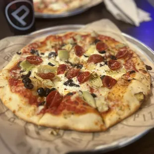 a pizza with pepperoni and olives