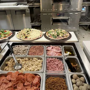 Pies ready to be cooked! The one on the right is a cauliflower crust and the one on the left is regular thin crust.