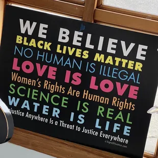 a sign in a window saying we believe black lives matter