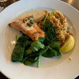 Seared salmon with sautéed spinach and dirty rice.
