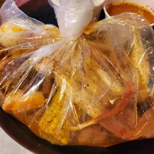 C1-Crab legs, shrimp, sausage, egg, corn, and potatoes in hot garlic butter sauce.