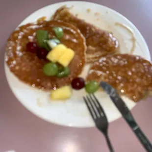 a plate of pancakes and fruit