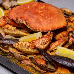 a crab and mussels on a tray
