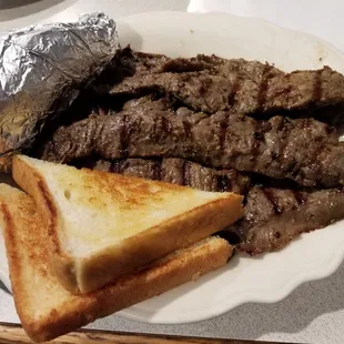 Marinated Beef Tips with Baked Potato and Grilled Toast. Also comes with Salad Bar (not pictured.)