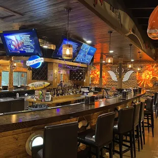 bar seating and televisions