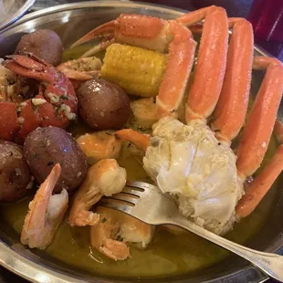 crab legs, potatoes, corn, and potatoes