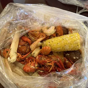 crab legs, corn, potatoes, and corn on the cob