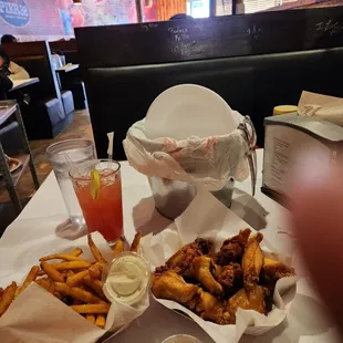 Cajun fries and chicken wings and strawberry margarita