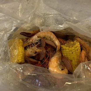 1/2lbs Shrimp (with Heads), 1/2lbs Crawfish and Sausage with Cajun Spice.